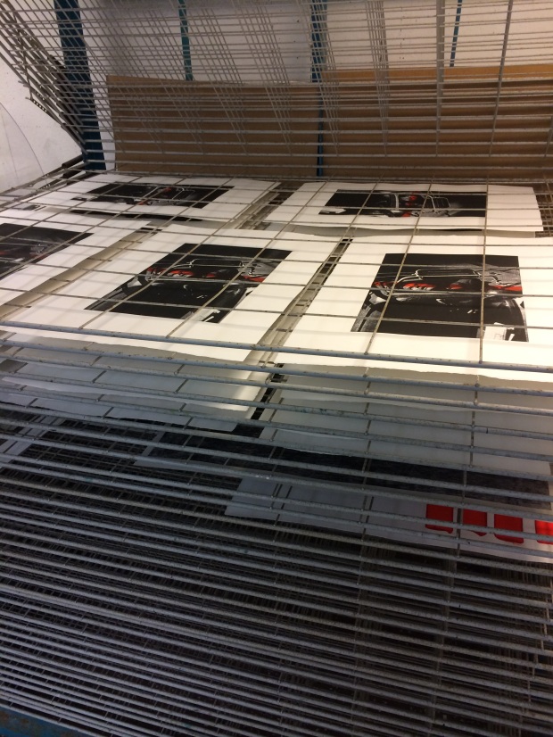 Full rack of complete prints ready for curation.